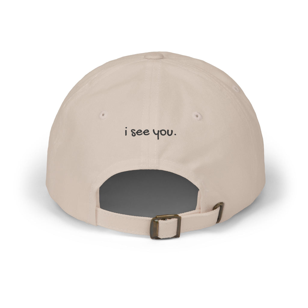 TUCURUCU beige cotton 6-panel cap with i see you embroidered above the adjustable antique brass strap back opening