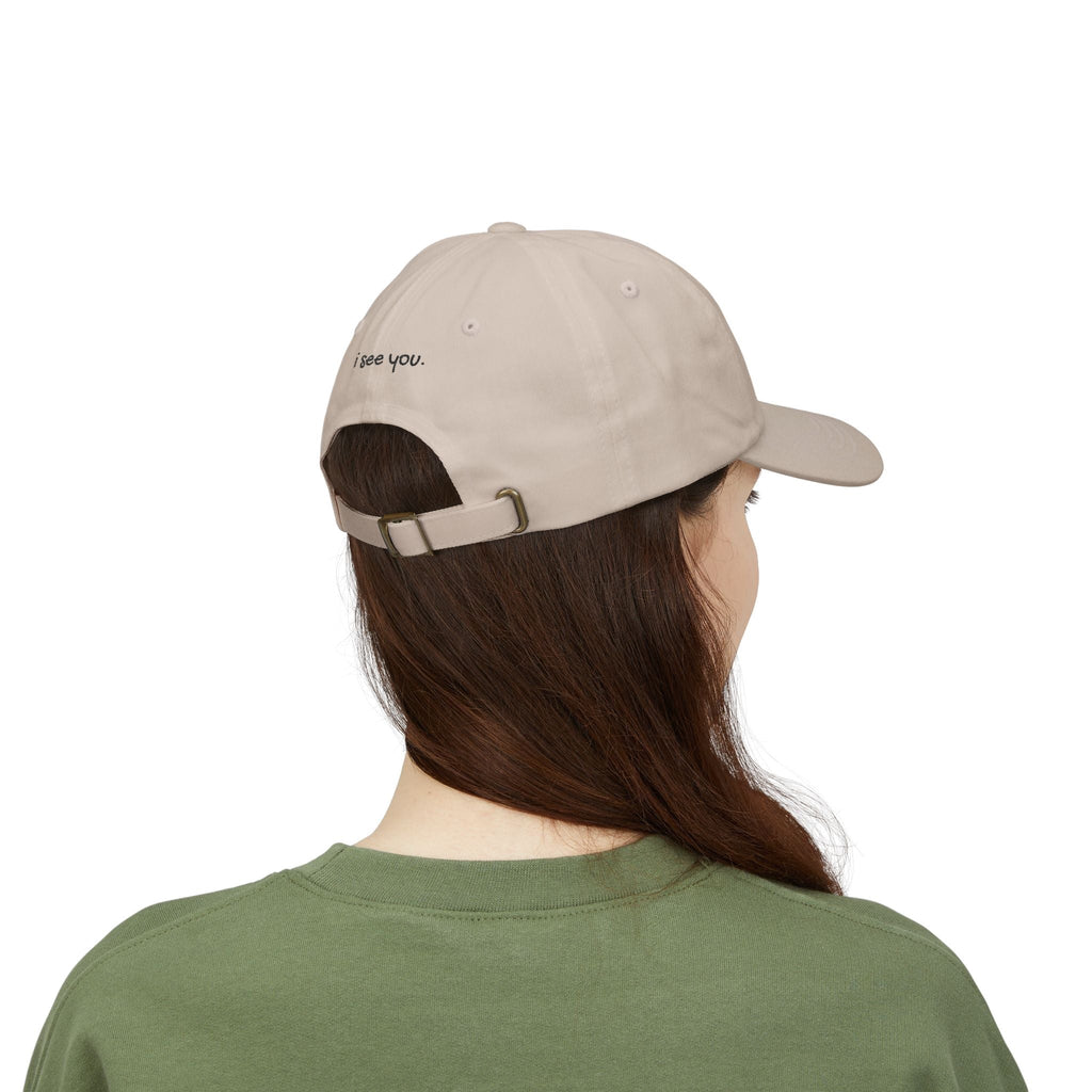 TUCURUCU beige cotton 6-panel cap with i see you embroidered above the antique brass adjustable back strap
