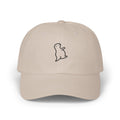 TUCURUCU beige unstructured cotton 6-panel cap with a small embroidered wistful character on the front.