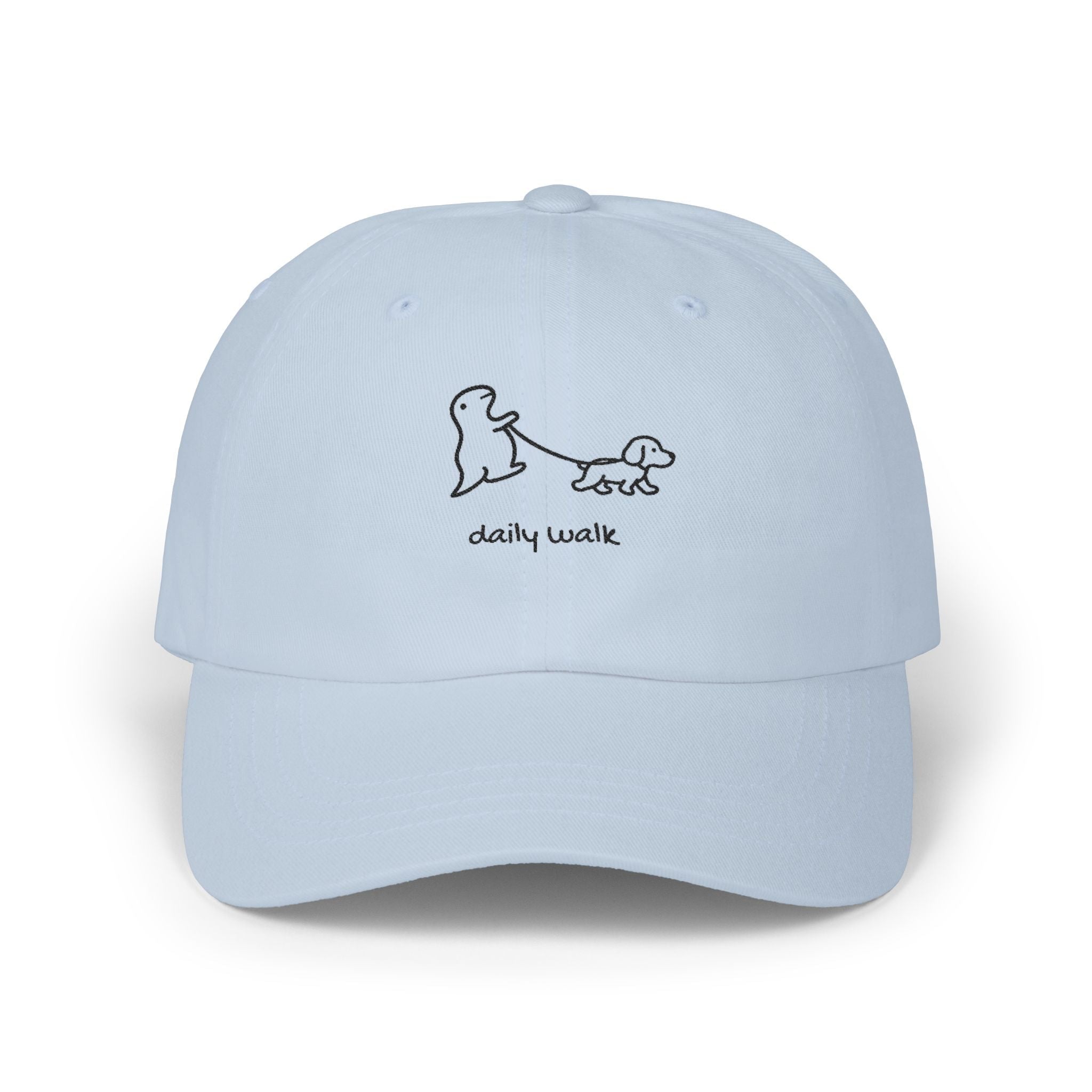 TUCURUCU light blue unstructured cotton baseball cap with a cute embroidered dinosaur walking a dog and daily walk text.