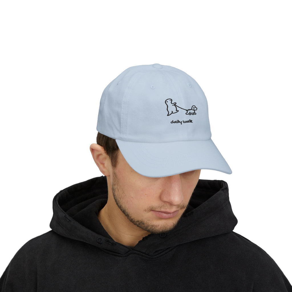 TUCURUCU light blue unstructured cotton baseball cap with embroidered dinosaur and dog daily walk graphic on a model